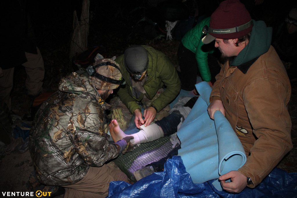 Wilderness First Responder student puts a splint on a leg during the 2015 WFR night rescue simulation.
